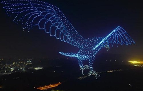 DAMODA drone light show forming an eagle in the night sky